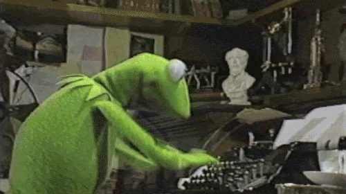 Kermit the Frog aggressively types on an old type writer.
