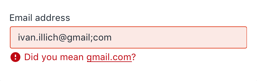 Screenshot of input field in an error state; red border, light red background, red error text with icon below.