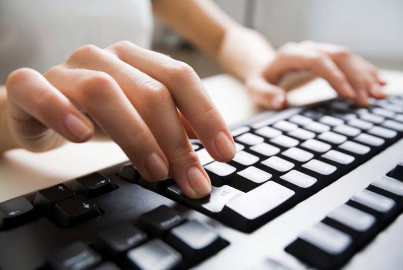 A person typing on a keyboard.