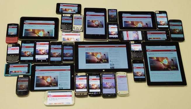 A table with various mobile phones and tablets.